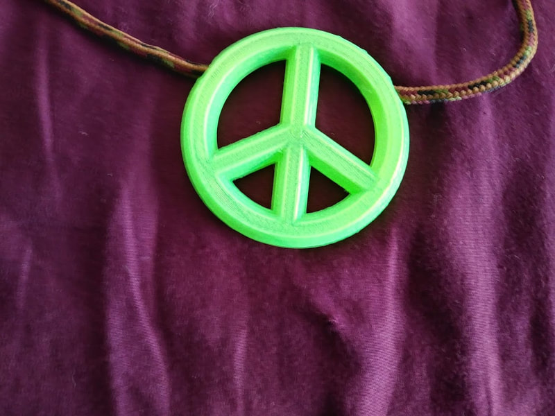 Peace symbol necklace, glow under UV plastic